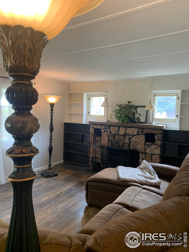 198 Poudre River Rd, Bellvue, CO 80512 - living room featuring a stone fireplace, baseboards, wood finished floors, and a healthy amount of sunlight