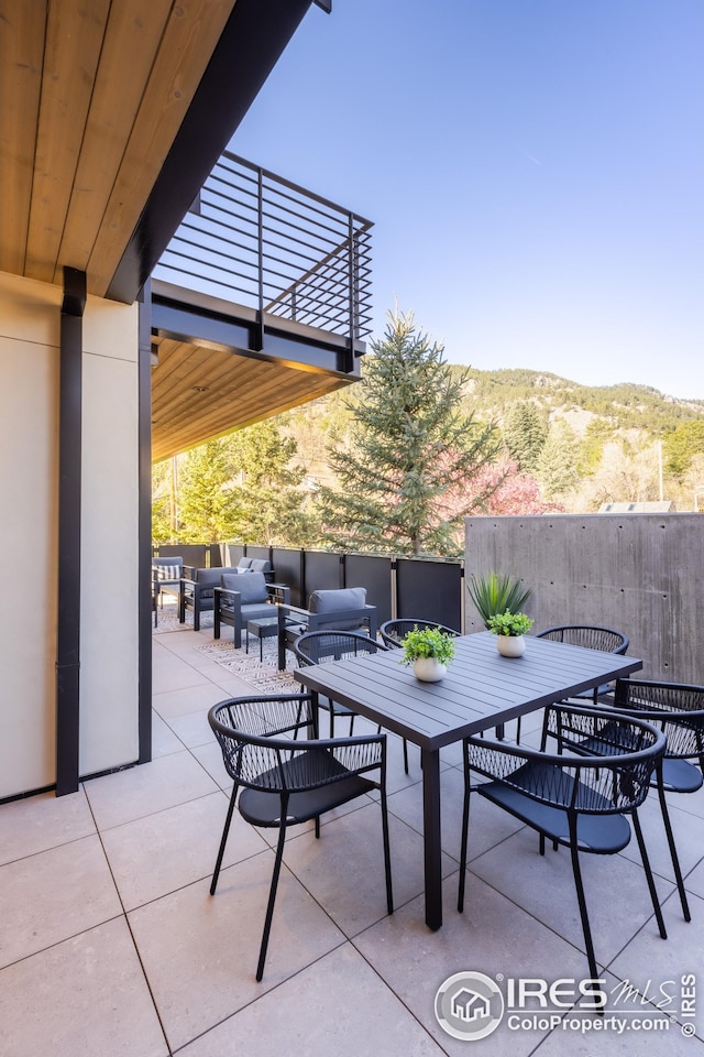 view of patio featuring outdoor lounge area, outdoor dining space, and a balcony