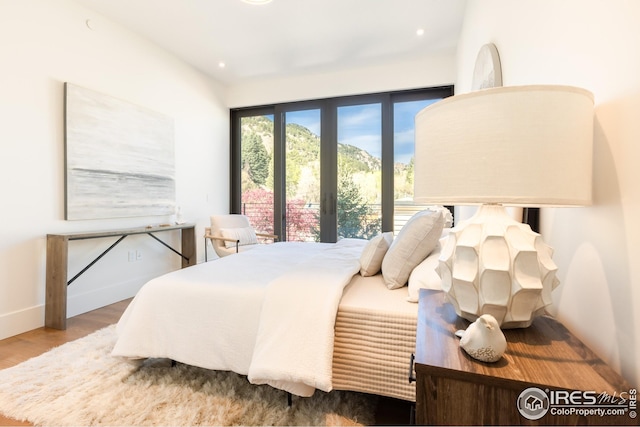 bedroom with wood finished floors and recessed lighting