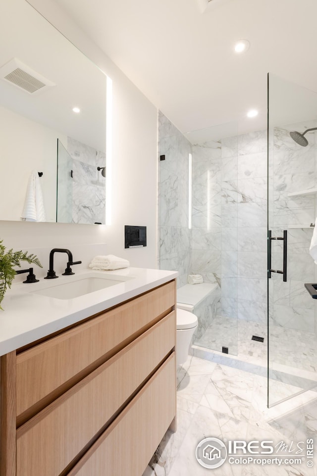 bathroom with a marble finish shower, vanity, marble finish floor, toilet, and visible vents