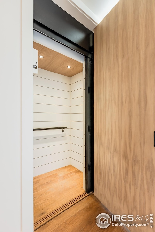 interior space with wood finished floors and recessed lighting