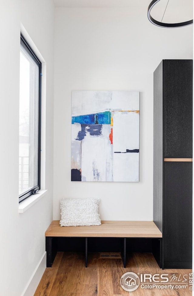 mudroom featuring baseboards and wood finished floors