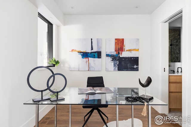 office area with wood finished floors and baseboards