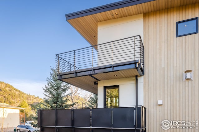 view of side of property with a balcony