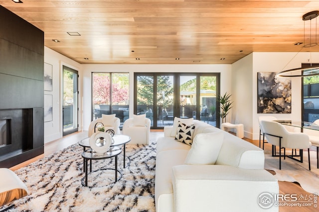 living area featuring baseboards, wood finished floors, and wooden ceiling