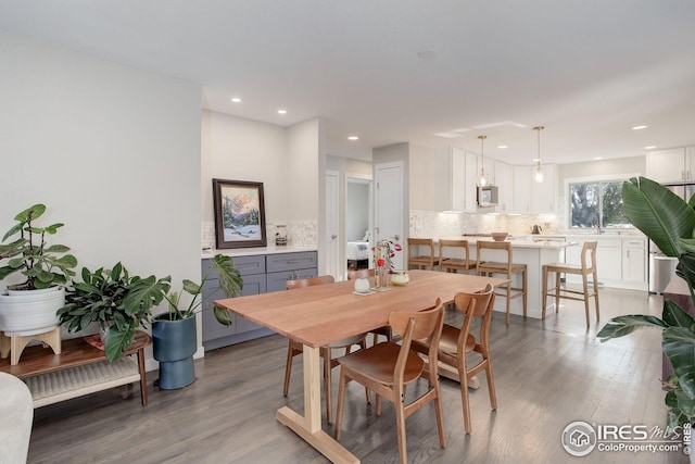 dining space with recessed lighting and light wood-style floors
