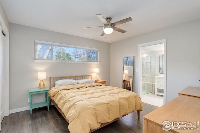 bedroom with connected bathroom, baseboards, dark wood finished floors, and a closet
