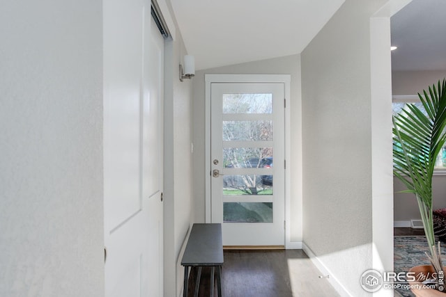 doorway to outside with baseboards, wood finished floors, vaulted ceiling, and visible vents