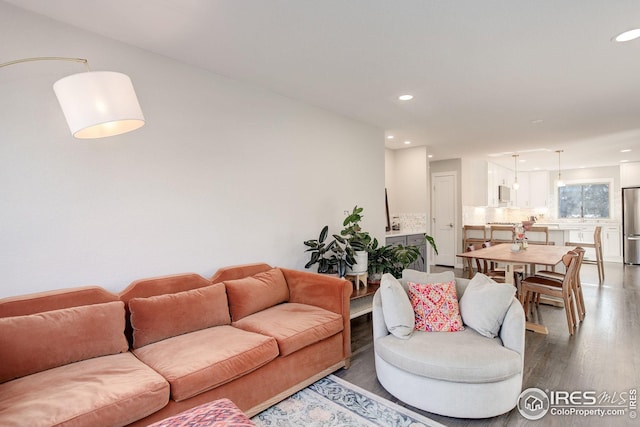living room with recessed lighting and wood finished floors