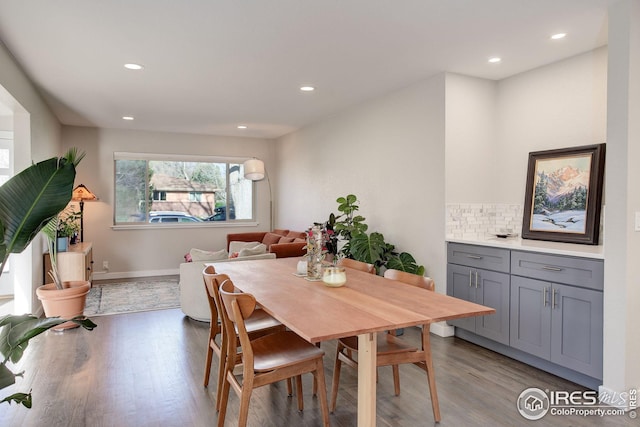 dining space featuring baseboards, recessed lighting, and wood finished floors