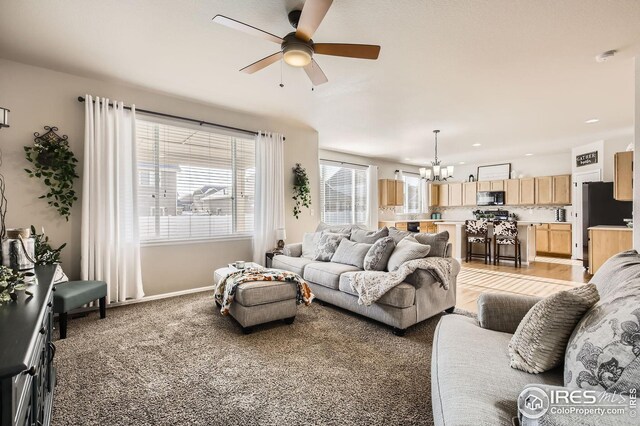 273 Mt Harvard Ave, Severance, CO 80550 - living area with recessed lighting, baseboards, light colored carpet, and ceiling fan with notable chandelier