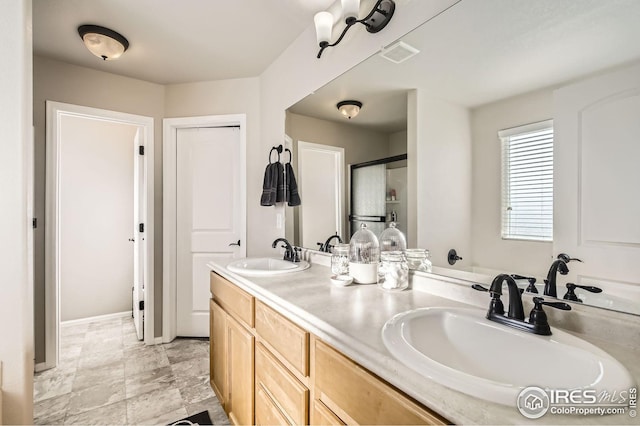 273 Mt Harvard Ave, Severance, CO 80550 - bathroom featuring visible vents, a sink, a shower with door, and double vanity