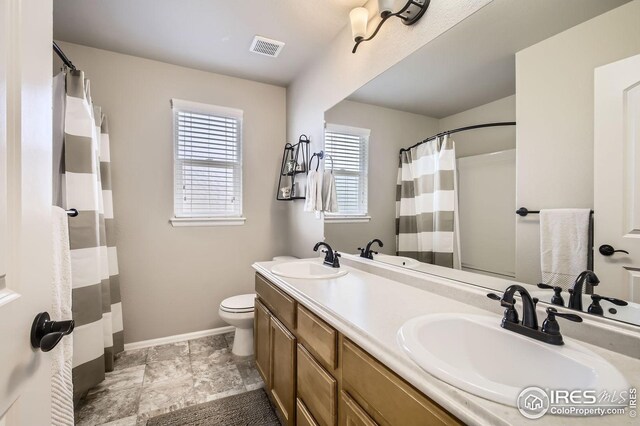273 Mt Harvard Ave, Severance, CO 80550 - bathroom with a sink, baseboards, toilet, and visible vents