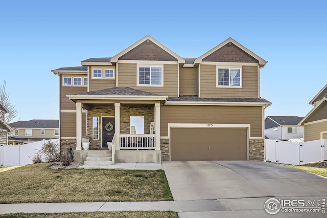 273 Mt Harvard Ave, Severance, CO 80550 - craftsman-style home with an attached garage, fence, covered porch, and concrete driveway