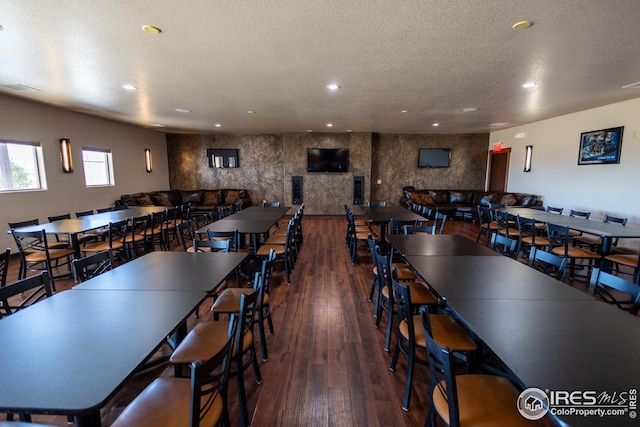dining room featuring recessed lighting, wood-type flooring, visible vents, and a textured ceiling
