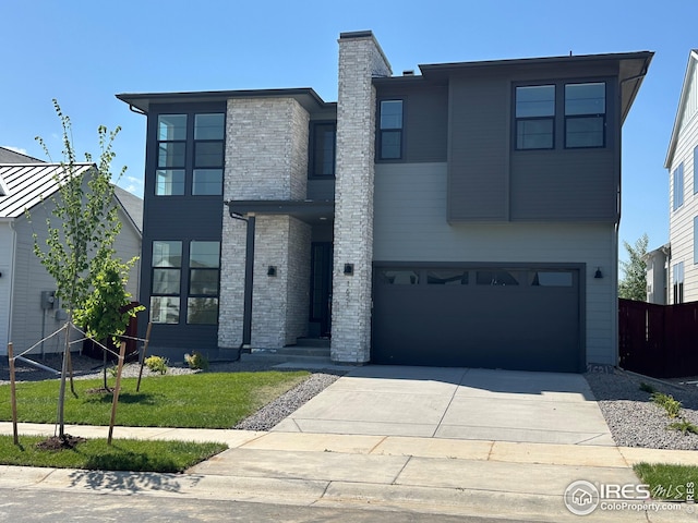 1621 Winter Glow Dr, Windsor, CO 80550 - contemporary home with an attached garage, concrete driveway, and a chimney