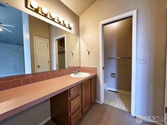 full bathroom with toilet, visible vents, decorative backsplash, a ceiling fan, and vanity