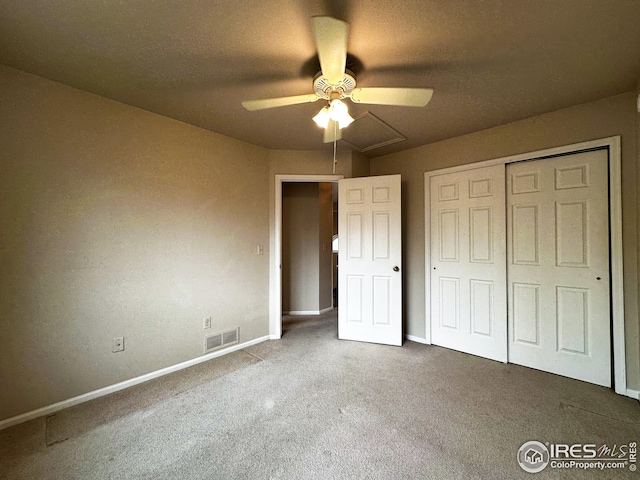 unfurnished bedroom featuring carpet flooring, baseboards, visible vents, a closet, and ceiling fan