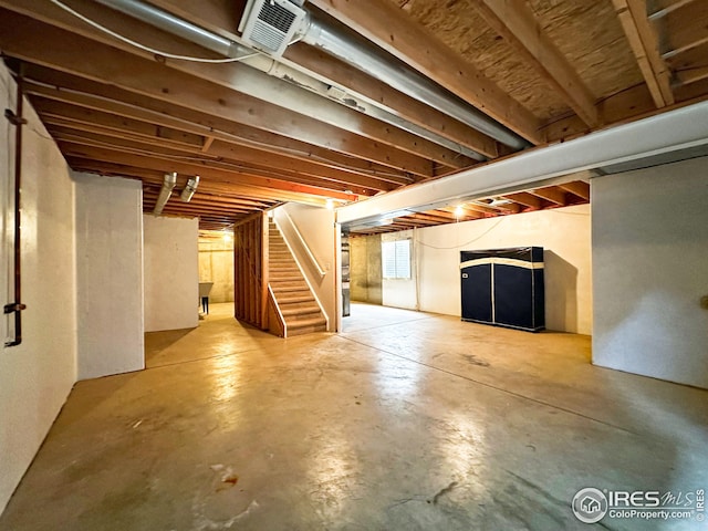 basement with stairs and visible vents
