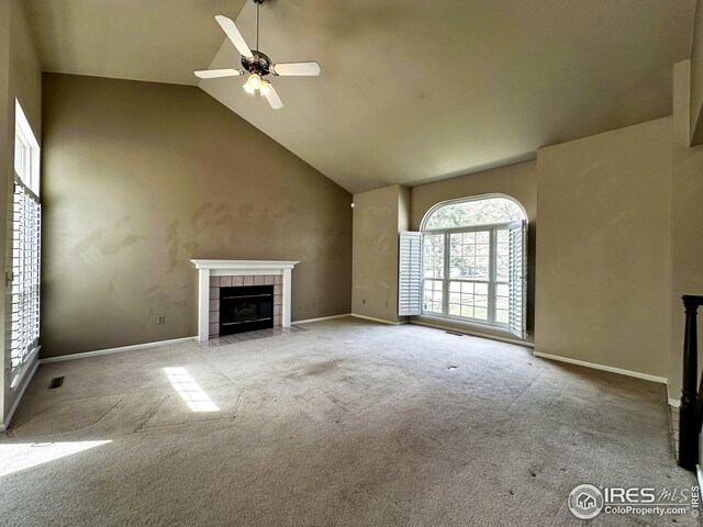 unfurnished living room with a fireplace, carpet floors, high vaulted ceiling, and ceiling fan