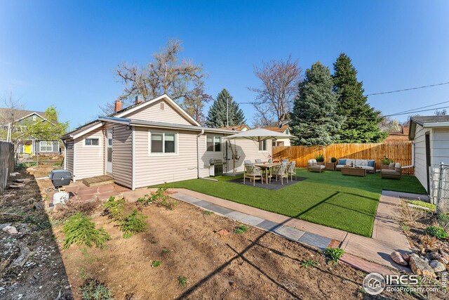 back of house featuring fence and a yard