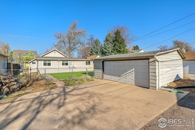 detached garage featuring fence