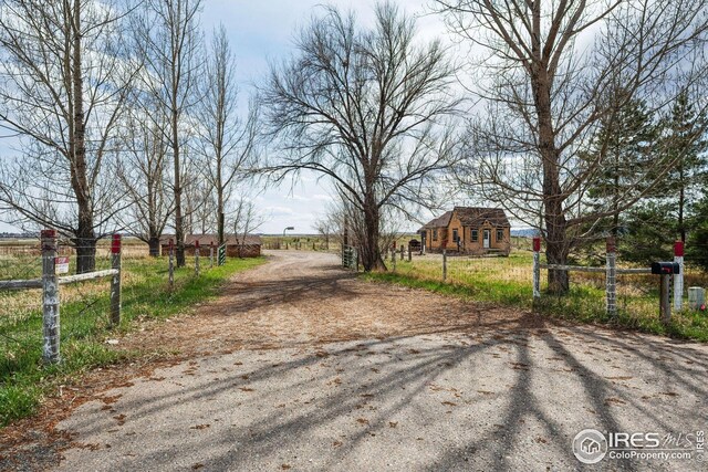 view of street with a gated entry and driveway