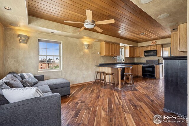 living area with a wealth of natural light, wood ceiling, and dark wood finished floors