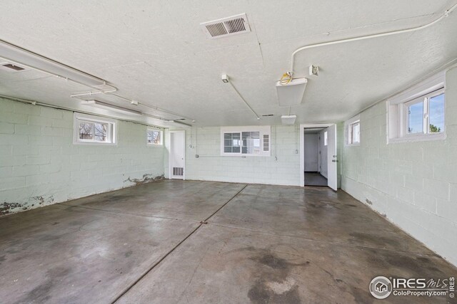 garage featuring visible vents and concrete block wall