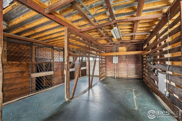 interior space with wooden walls and concrete flooring