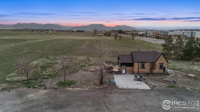 birds eye view of property with a rural view and a mountain view