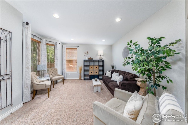 living area featuring baseboards, recessed lighting, and carpet