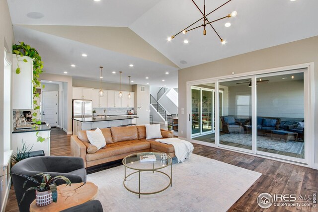 16335 Spanish Peak Way, Broomfield, CO 80023 - living room featuring lofted ceiling, recessed lighting, stairway, and dark wood finished floors