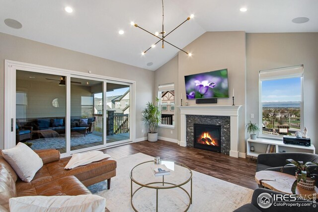 16335 Spanish Peak Way, Broomfield, CO 80023 - living area with recessed lighting, wood finished floors, a warm lit fireplace, and a notable chandelier
