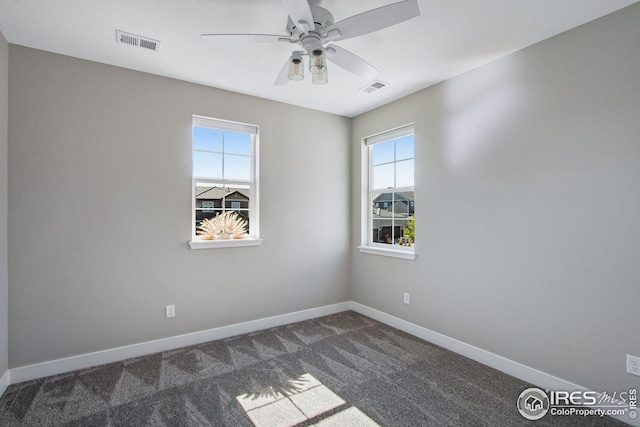 16335 Spanish Peak Way, Broomfield, CO 80023 - spare room featuring dark colored carpet, visible vents, and a wealth of natural light