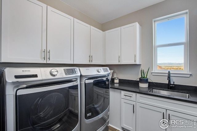 16335 Spanish Peak Way, Broomfield, CO 80023 - laundry area featuring washing machine and dryer, cabinet space, and a sink