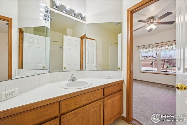 bathroom featuring ceiling fan, baseboards, and vanity