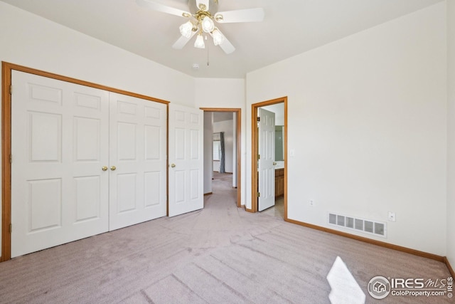 unfurnished bedroom featuring carpet, visible vents, a closet, and baseboards