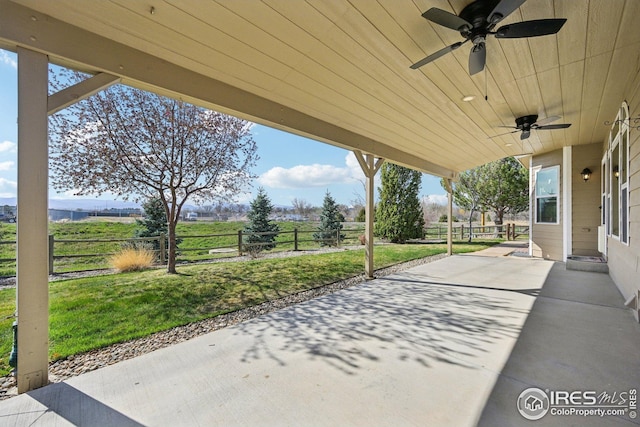 view of patio with fence and ceiling fan