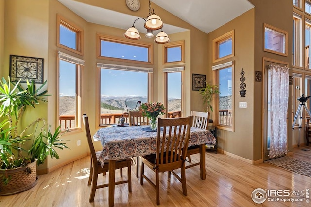9 Mummy View Ct, Livermore, CO 80536 - dining room with a high ceiling, a mountain view, baseboards, light wood-type flooring, and a chandelier