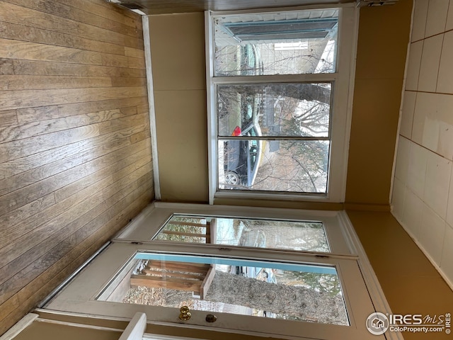unfurnished room with wooden walls