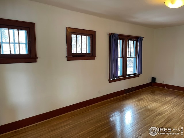 spare room with plenty of natural light and baseboards