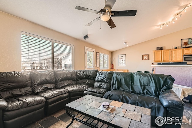 living room with ceiling fan and lofted ceiling