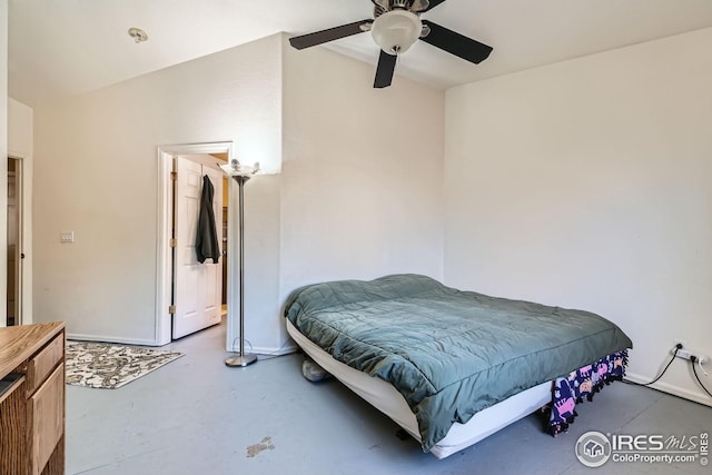 bedroom with a ceiling fan and finished concrete flooring