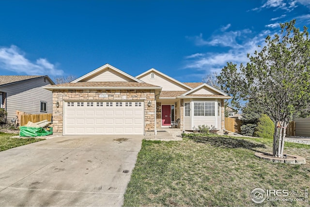 single story home with stone siding, fence, a garage, and concrete driveway