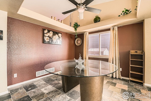dining area featuring ceiling fan, baseboards, stone tile flooring, and visible vents