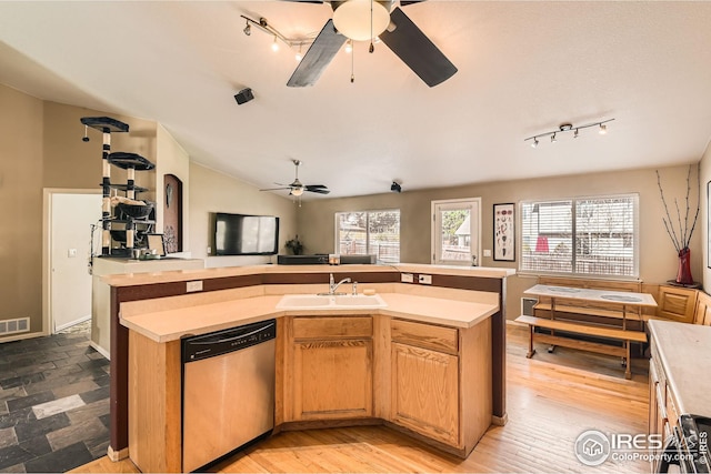 kitchen featuring a sink, open floor plan, ceiling fan, dishwasher, and rail lighting