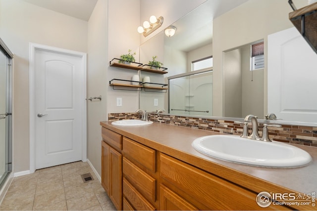 full bathroom with decorative backsplash, a sink, double vanity, and a stall shower
