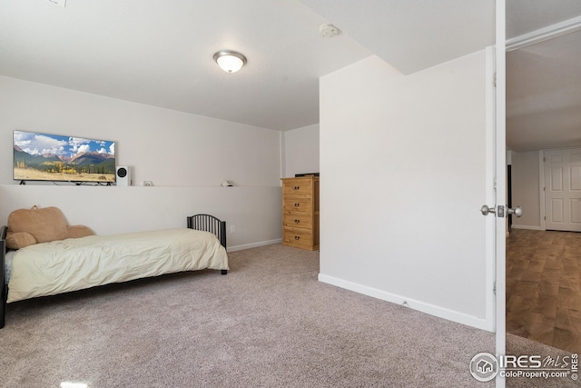 bedroom with baseboards and carpet floors
