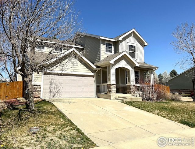 craftsman-style house with stone siding, concrete driveway, covered porch, a garage, and fence